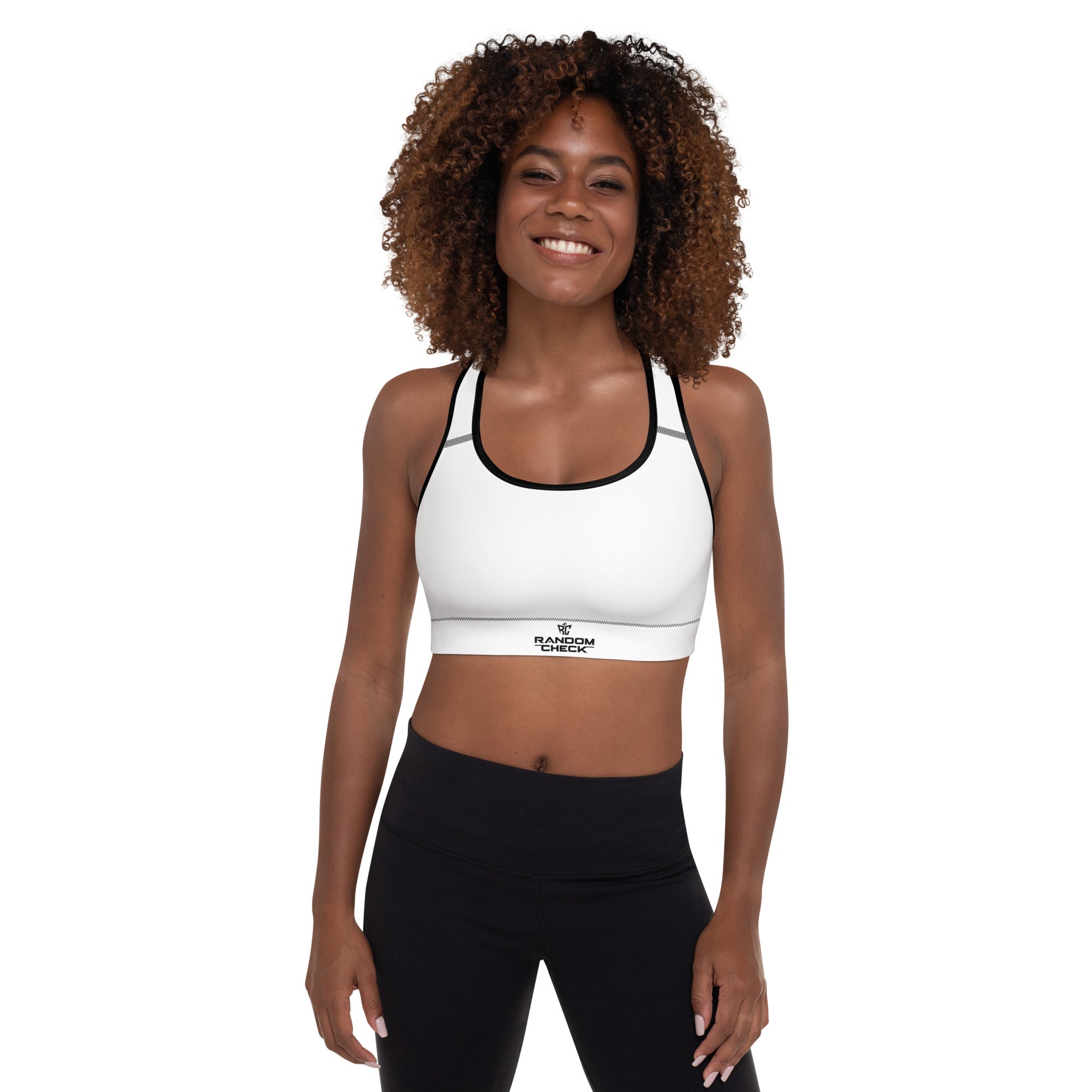 Woman wearing a white sports bra and black leggings on a white background
