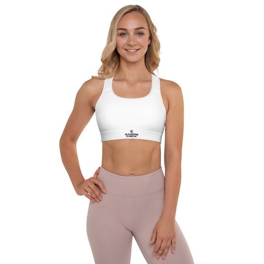 Woman wearing a white sports bra and pink leggings on a white background