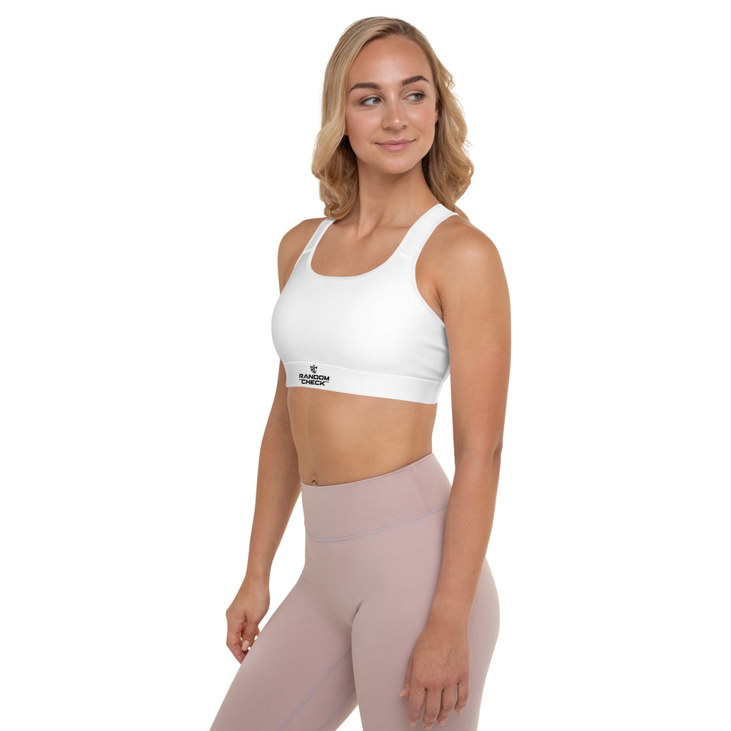 Woman wearing a white sports bra and pink leggings on a white background