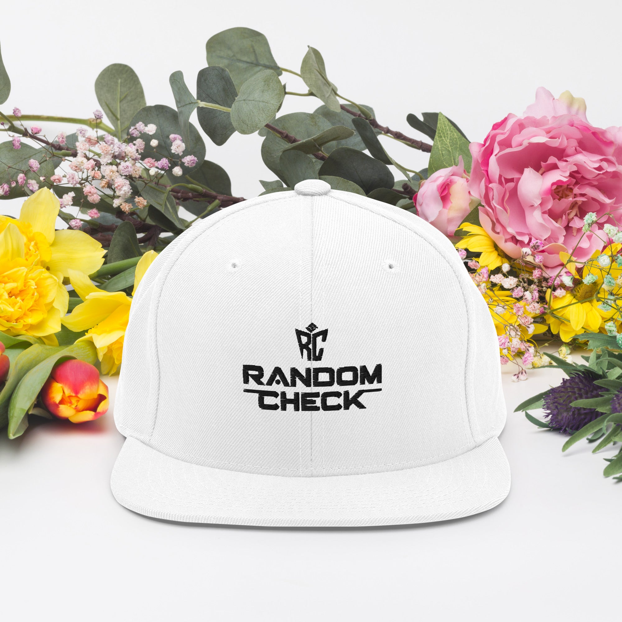 White cap with 'RANDOM CHECK' logo on a white background with flowers