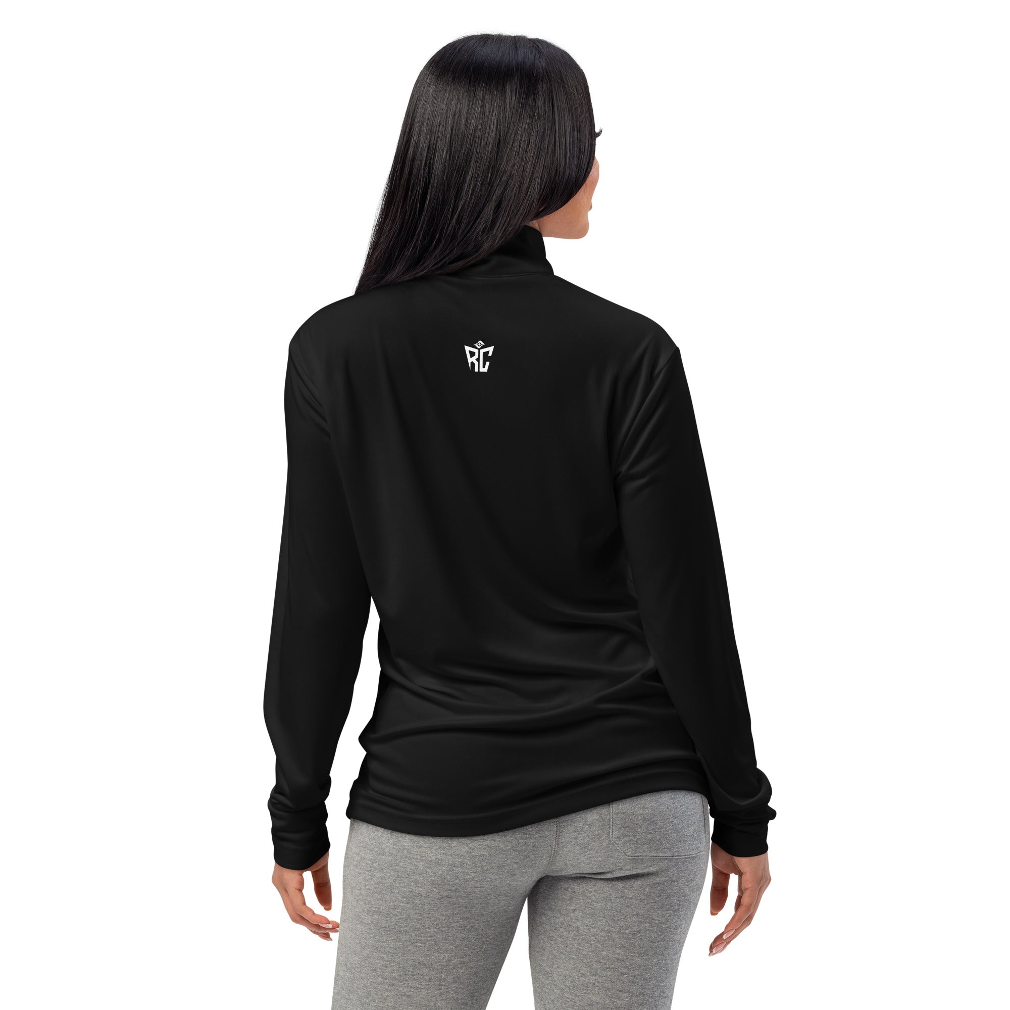 Person wearing a black long-sleeve shirt with text on the back, standing against a white background