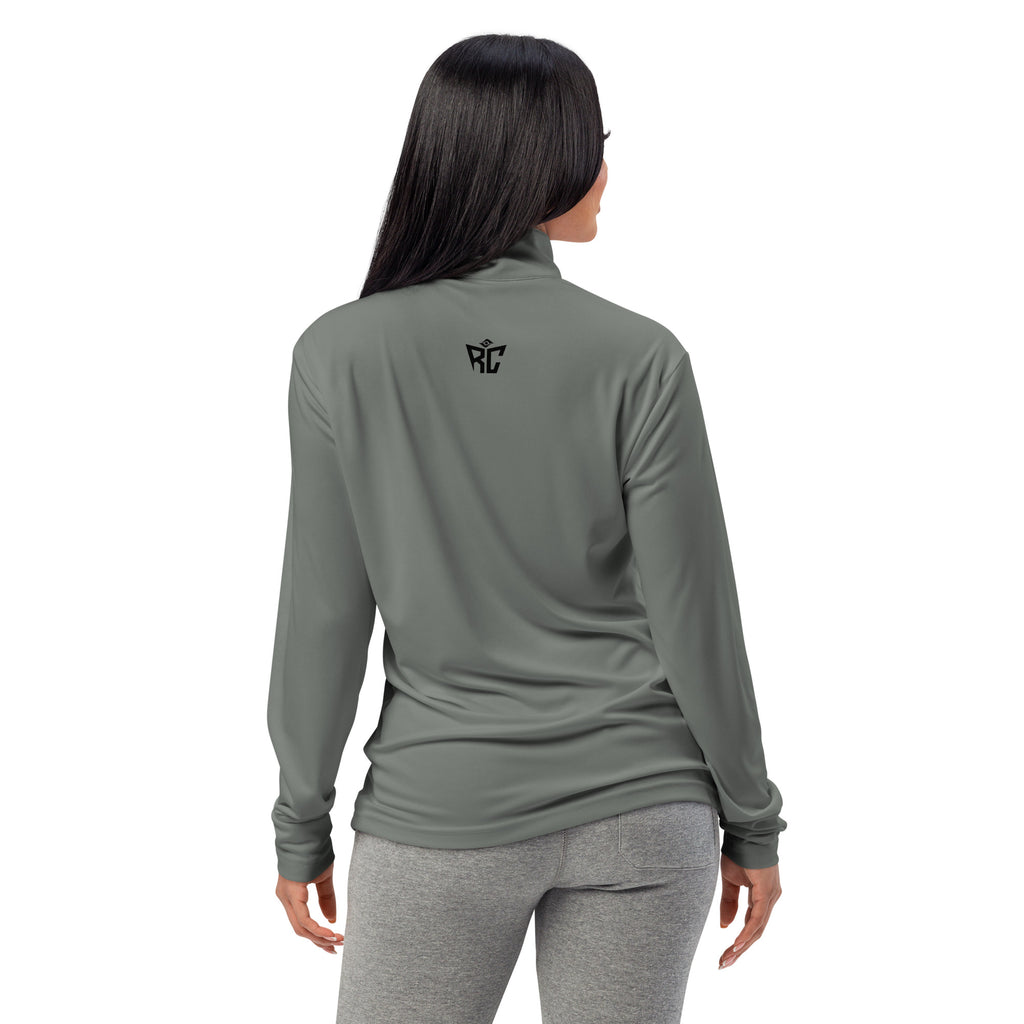 Woman wearing a green long-sleeve athletic top and gray leggings on a white background
