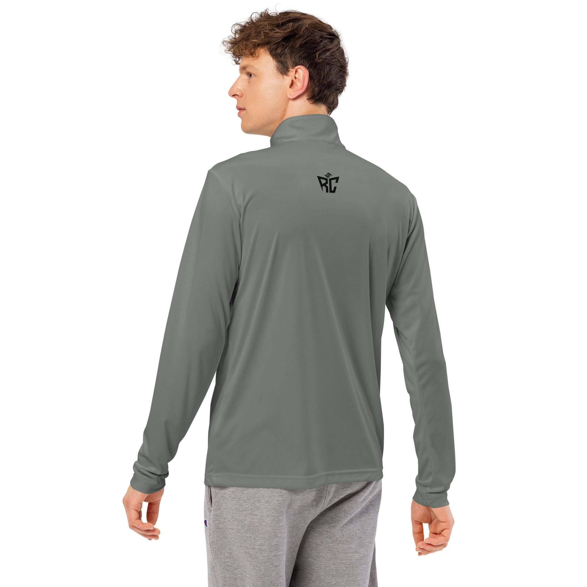Person wearing a gray long-sleeve shirt with a logo on the back against a white background