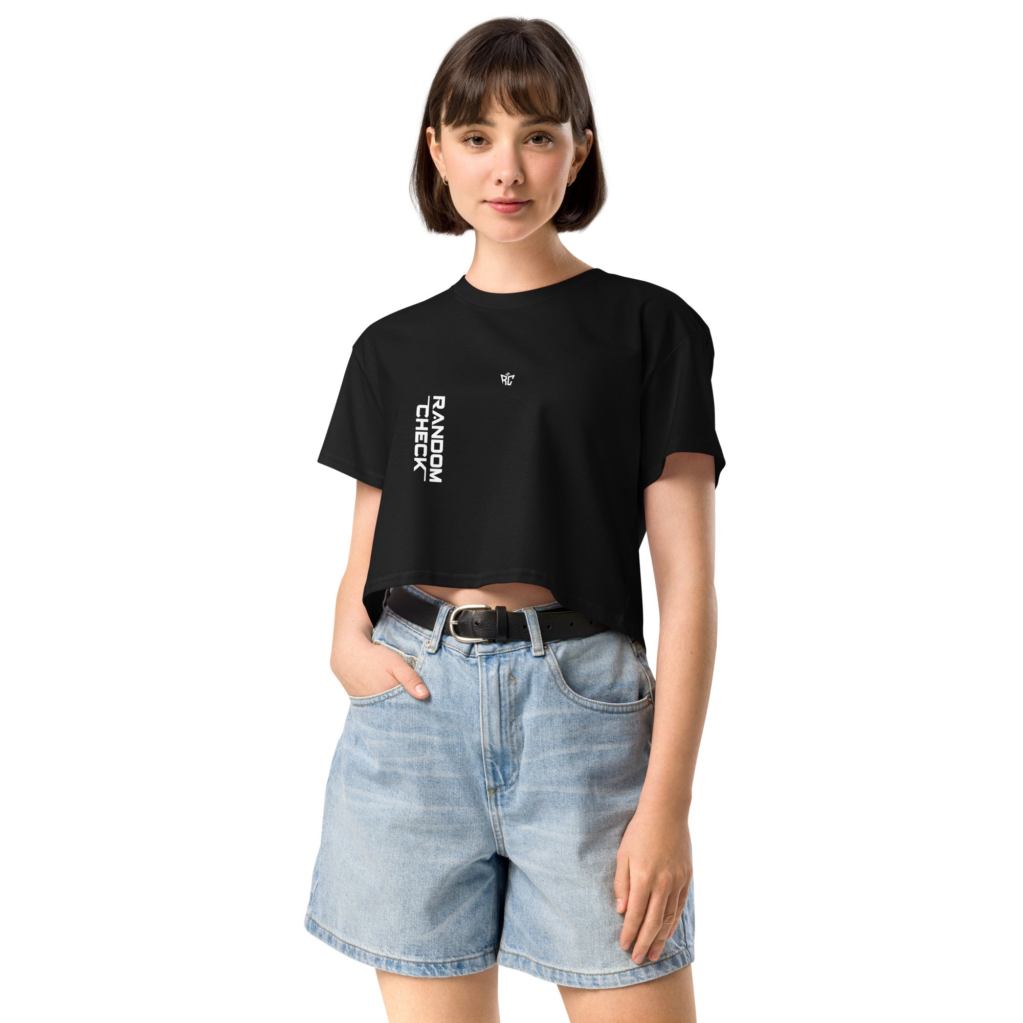 Person wearing a black t-shirt with text and light blue shorts on a white background
