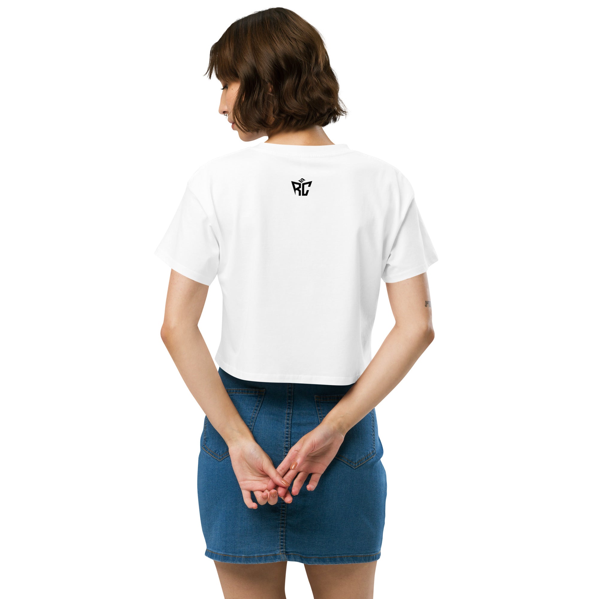 Person wearing a white t-shirt with a logo on the back, standing against a white background